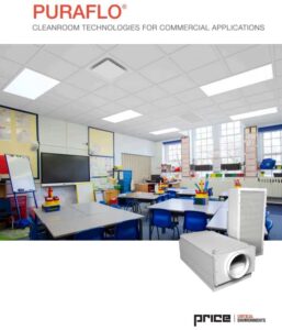 A classroom with arranged tables and blue chairs, equipped with learning materials, and featuring a cleanroom technology ceiling. There is an interactive whiteboard and large windows. Heating or air purification equipment is displayed in the foreground.